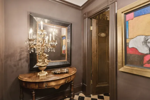 a room with a table and a chandelier