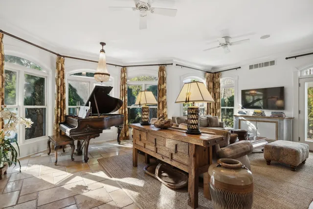 a living room with furniture gym equipment and a large window