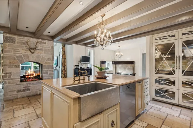 a kitchen that has a sink a stove and a microwave oven in it