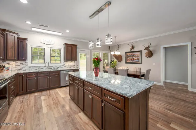 a bedroom that has a bed a dresser and a window