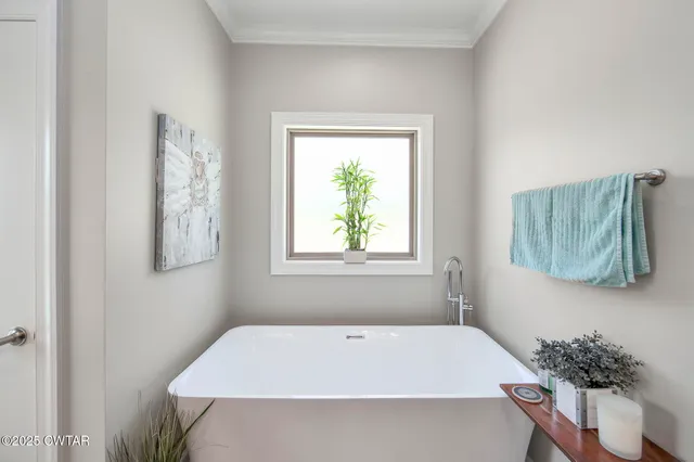 a view of walk in closet with clothes