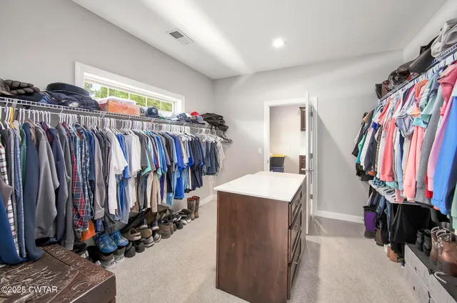 a kitchen with stainless steel appliances granite countertop a lot of clutter on the wall and cabinets