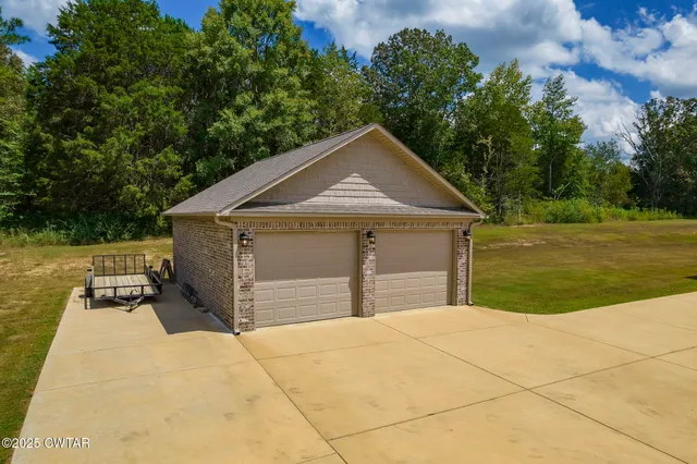 a view of a backyard with a table and chairs