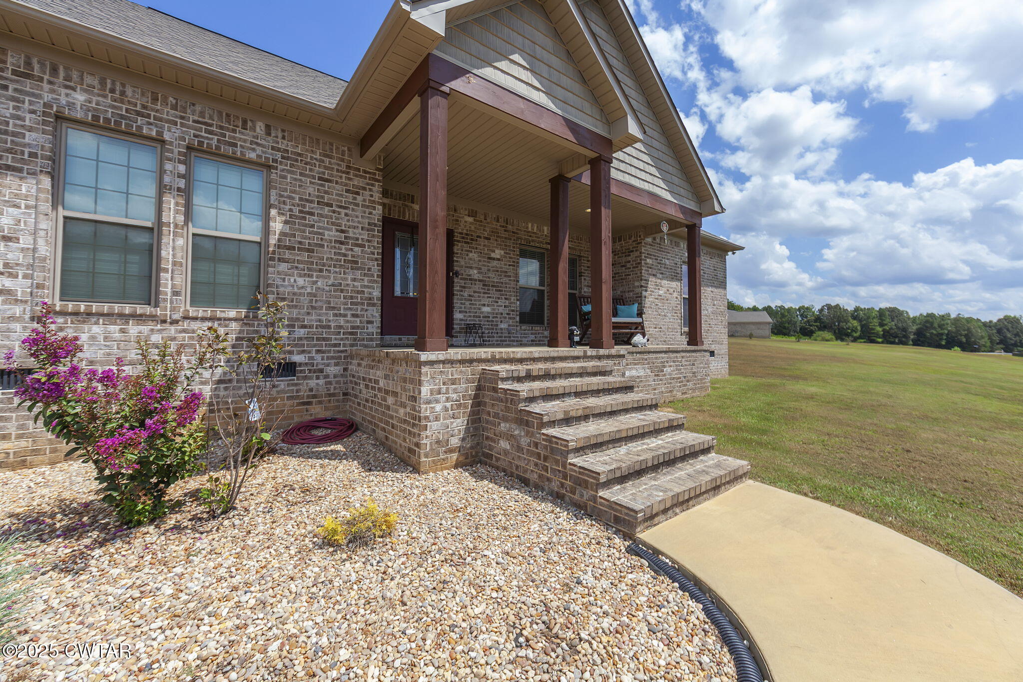 240 Greystone Cv Street Henderson, TN 38340 - Photo 8 of 64 a front view of a house with a garden
