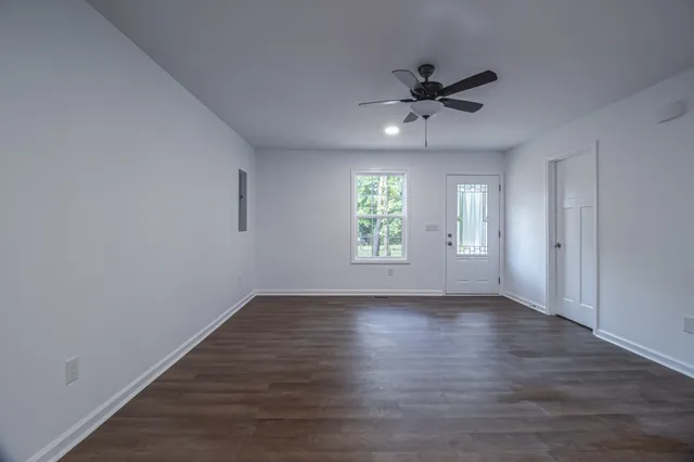 wooden floor in an empty room with a window