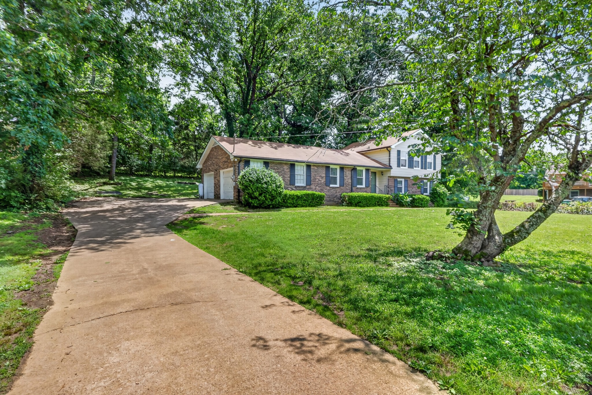 489 Canton Pass Madison, TN 37115 - Photo 3 of 25 a view of a house with a big yard plants and large trees
