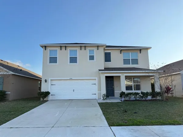 a front view of house with a garden