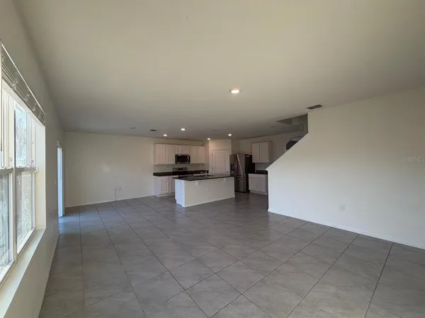 a view of kitchen with refrigerator and microwave