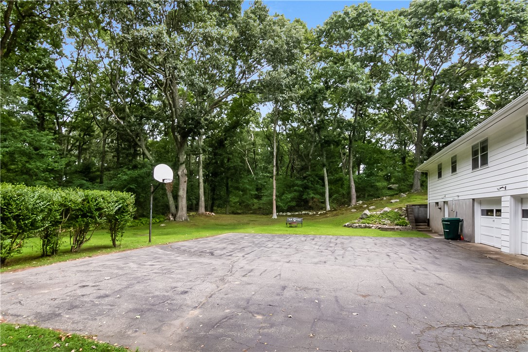 5435 Post Road Charlestown, RI 02813 - Photo 20 of 20 Parking area, basketball court, and intergral 2 car garage with walk out basement
