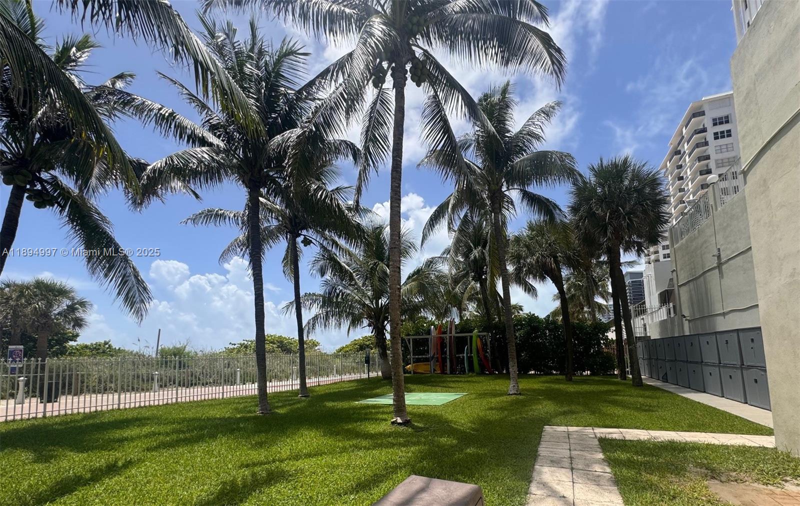 6061 Collins Avenue, Unit 10C Miami Beach, FL 33140 - Photo 12 of 45 a view of a park with palm trees