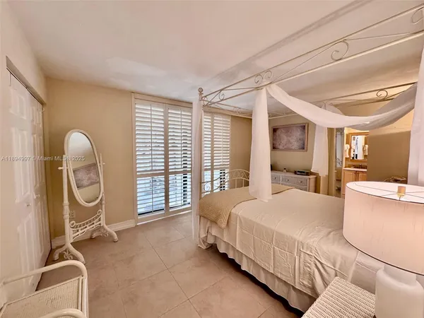 a bedroom with a bed a table and chair