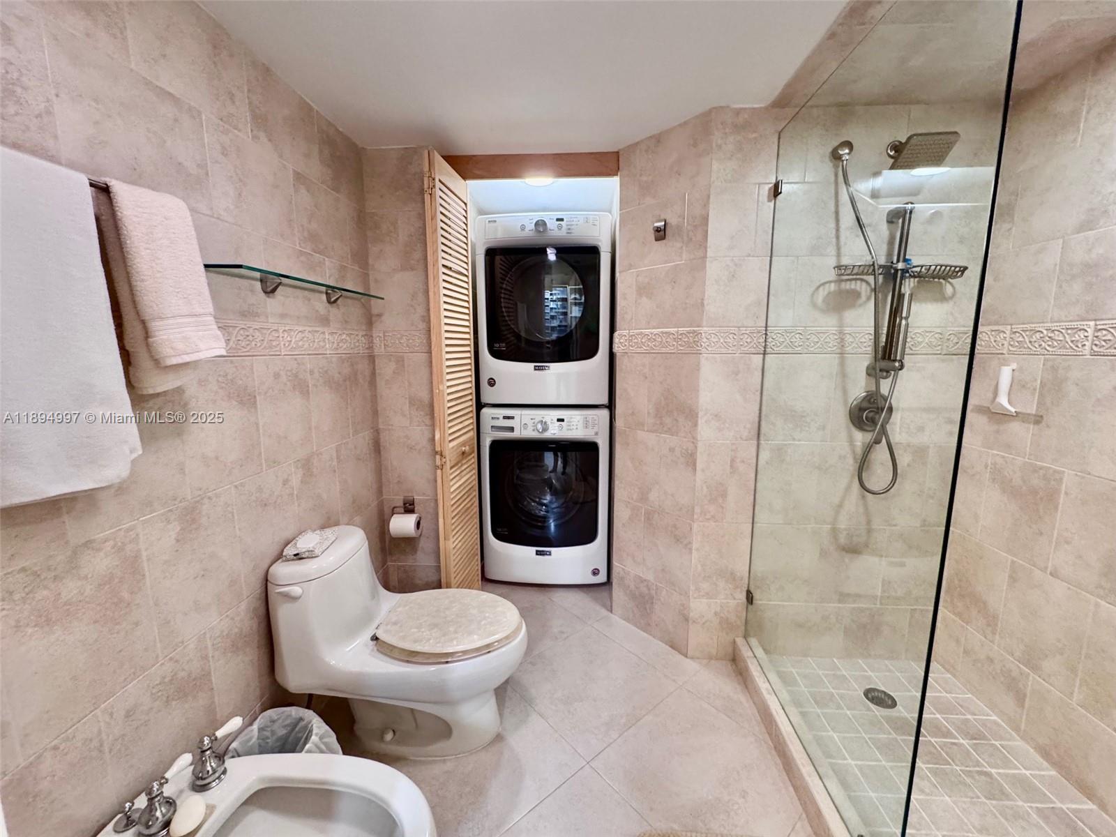 6061 Collins Avenue, Unit 10C Miami Beach, FL 33140 - Photo 15 of 45 a bathroom with a toilet and a shower