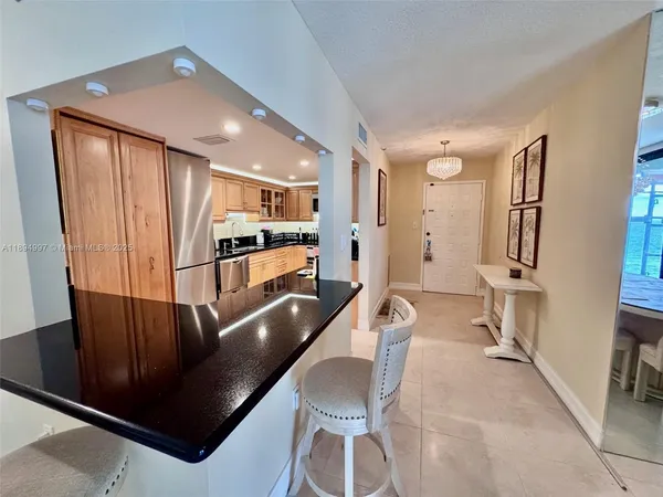 a kitchen with stainless steel appliances granite countertop a refrigerator and a sink