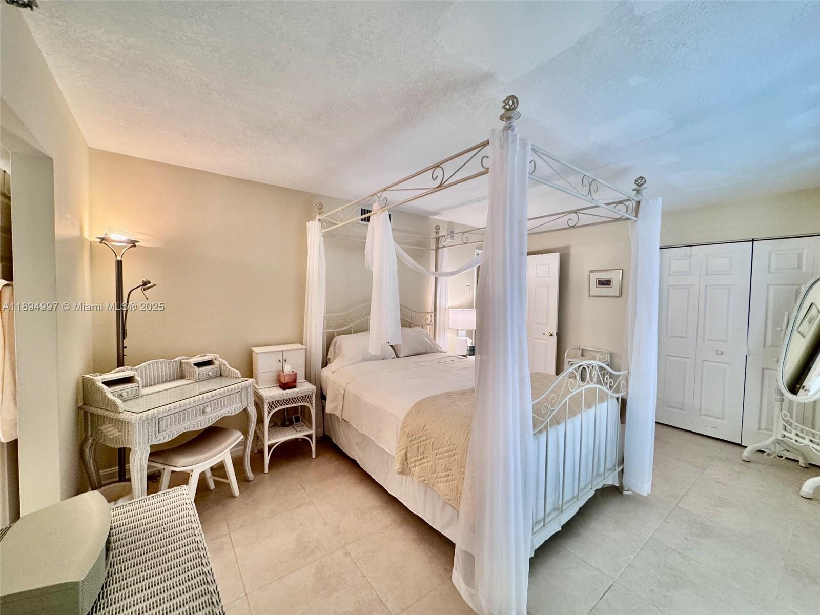 6061 Collins Avenue, Unit 10C Miami Beach, FL 33140 - Photo 2 of 45 a bed room with a bed and a window