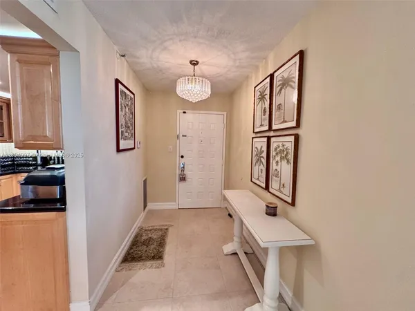 a view of a hallway with workspace and a window