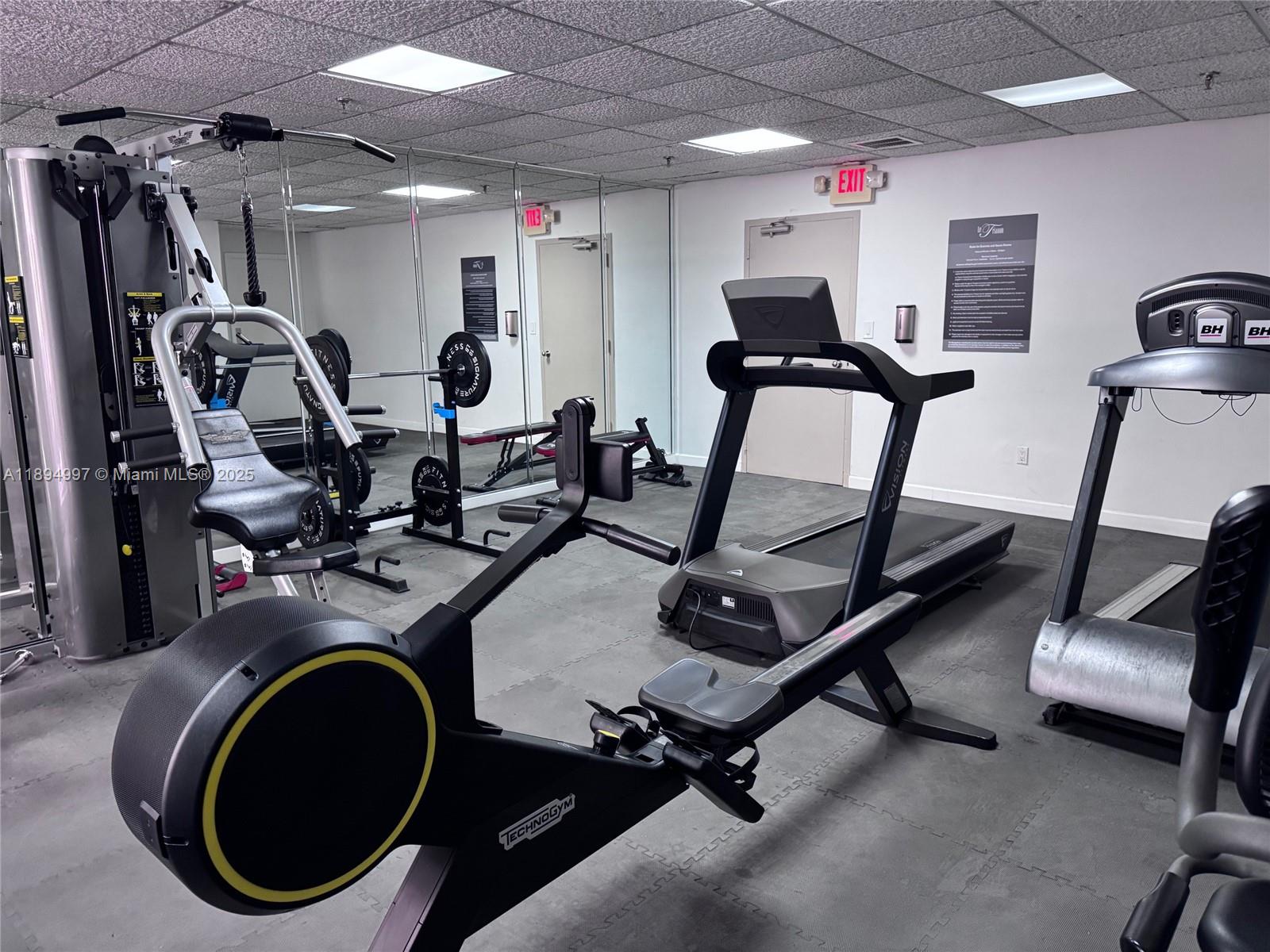 6061 Collins Avenue, Unit 10C Miami Beach, FL 33140 - Photo 26 of 45 a room with gym equipment