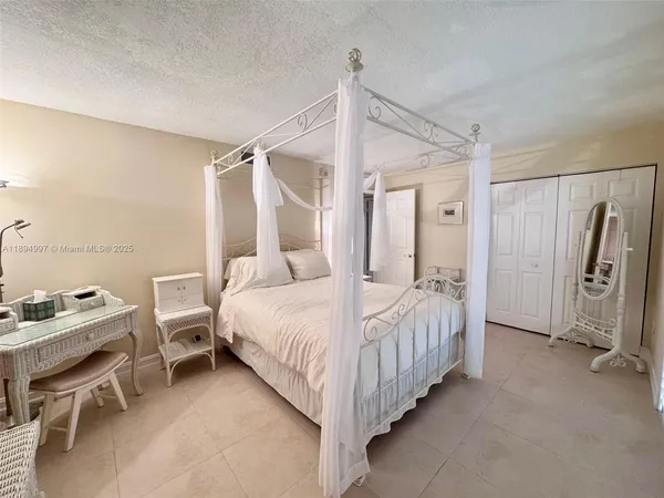 a bedroom with a bed and a chair