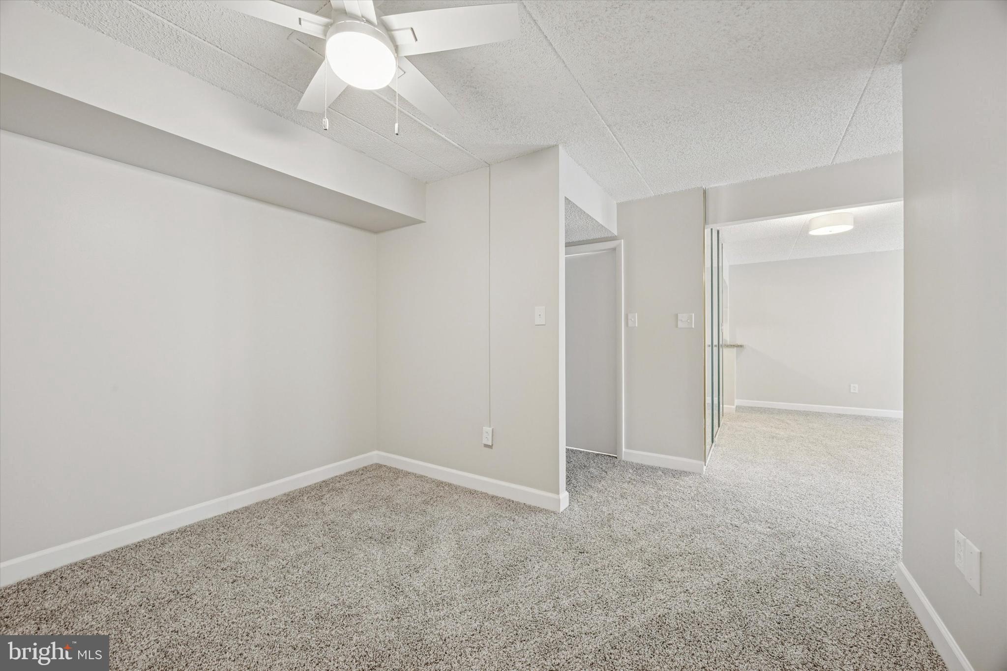 800 Avondale Road, Unit 7B Wallingford, PA 19086 - Photo 11 of 24 an empty room with a ceiling fan and a window