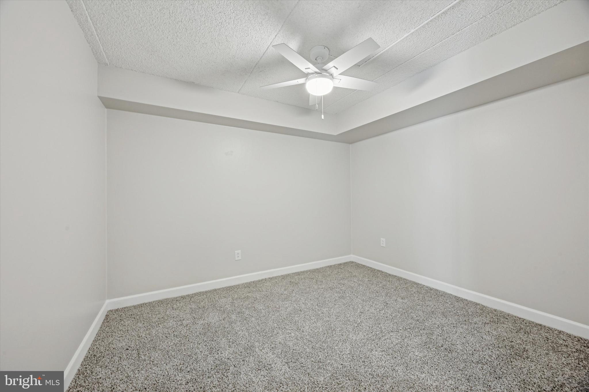 800 Avondale Road, Unit 7B Wallingford, PA 19086 - Photo 12 of 24 an empty room with a chandelier fan