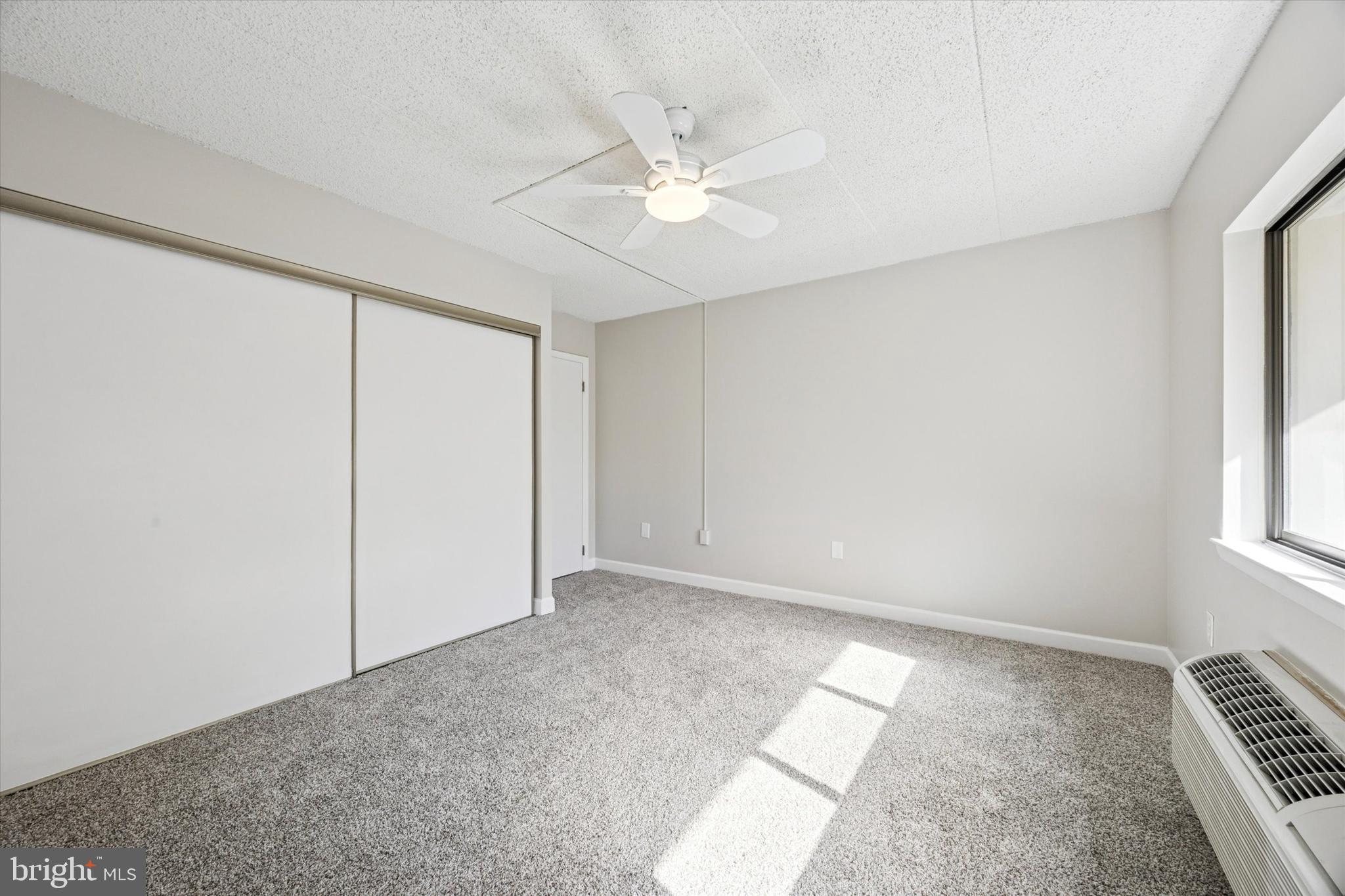 800 Avondale Road, Unit 7B Wallingford, PA 19086 - Photo 15 of 24 an empty room with windows and fan