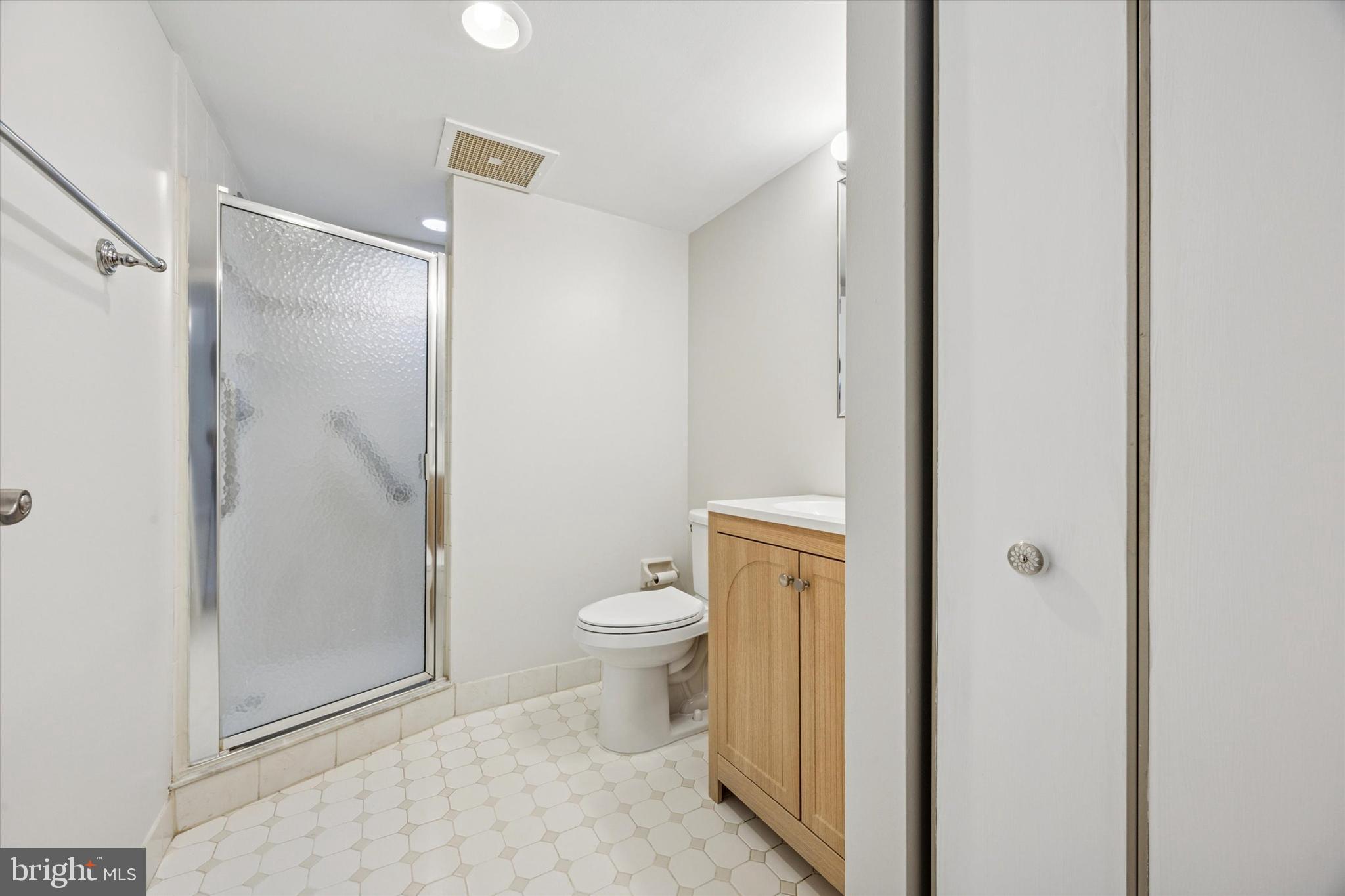 800 Avondale Road, Unit 7B Wallingford, PA 19086 - Photo 16 of 24 a bathroom with a granite countertop toilet and a shower