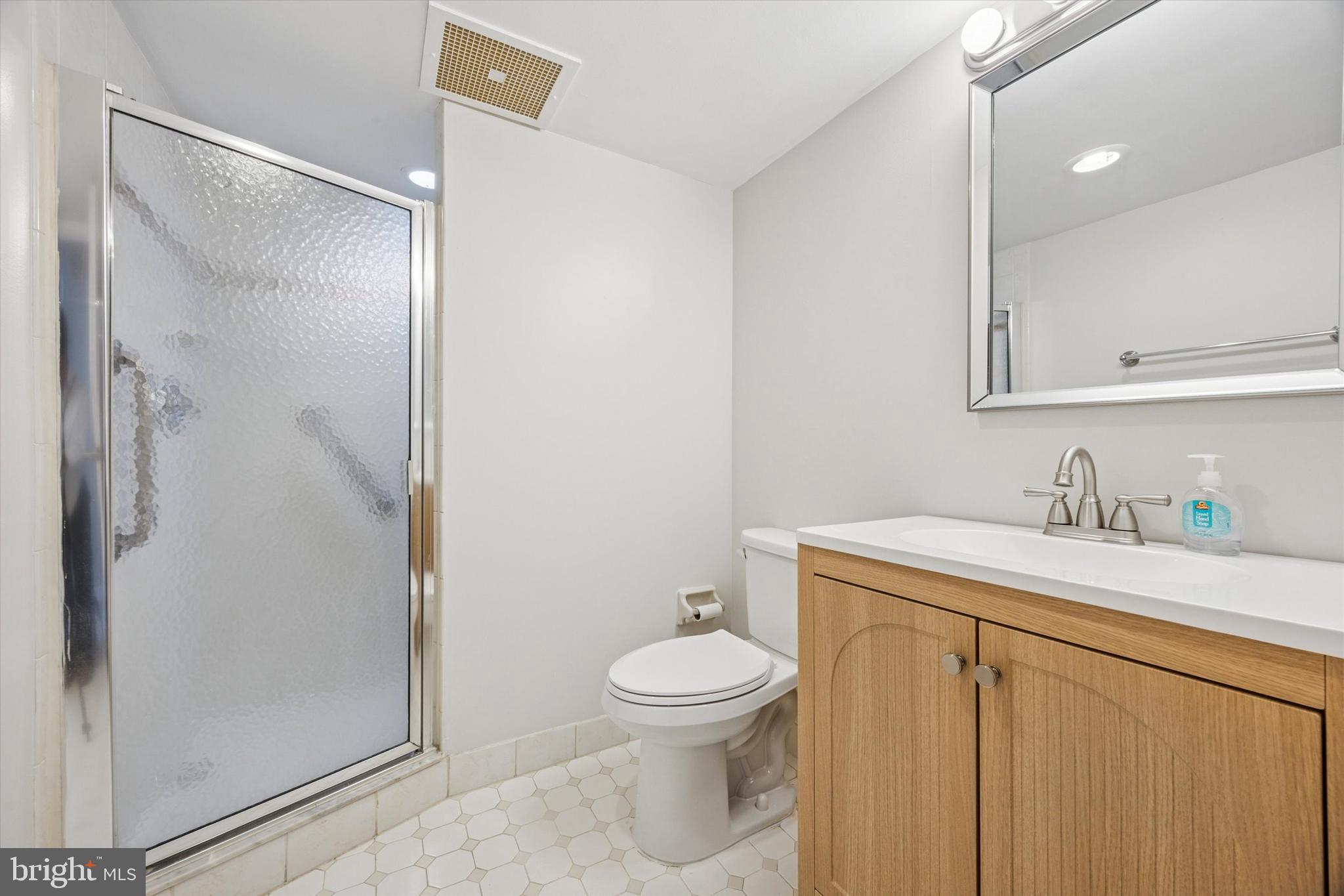 800 Avondale Road, Unit 7B Wallingford, PA 19086 - Photo 17 of 24 a bathroom with a granite countertop sink toilet and shower