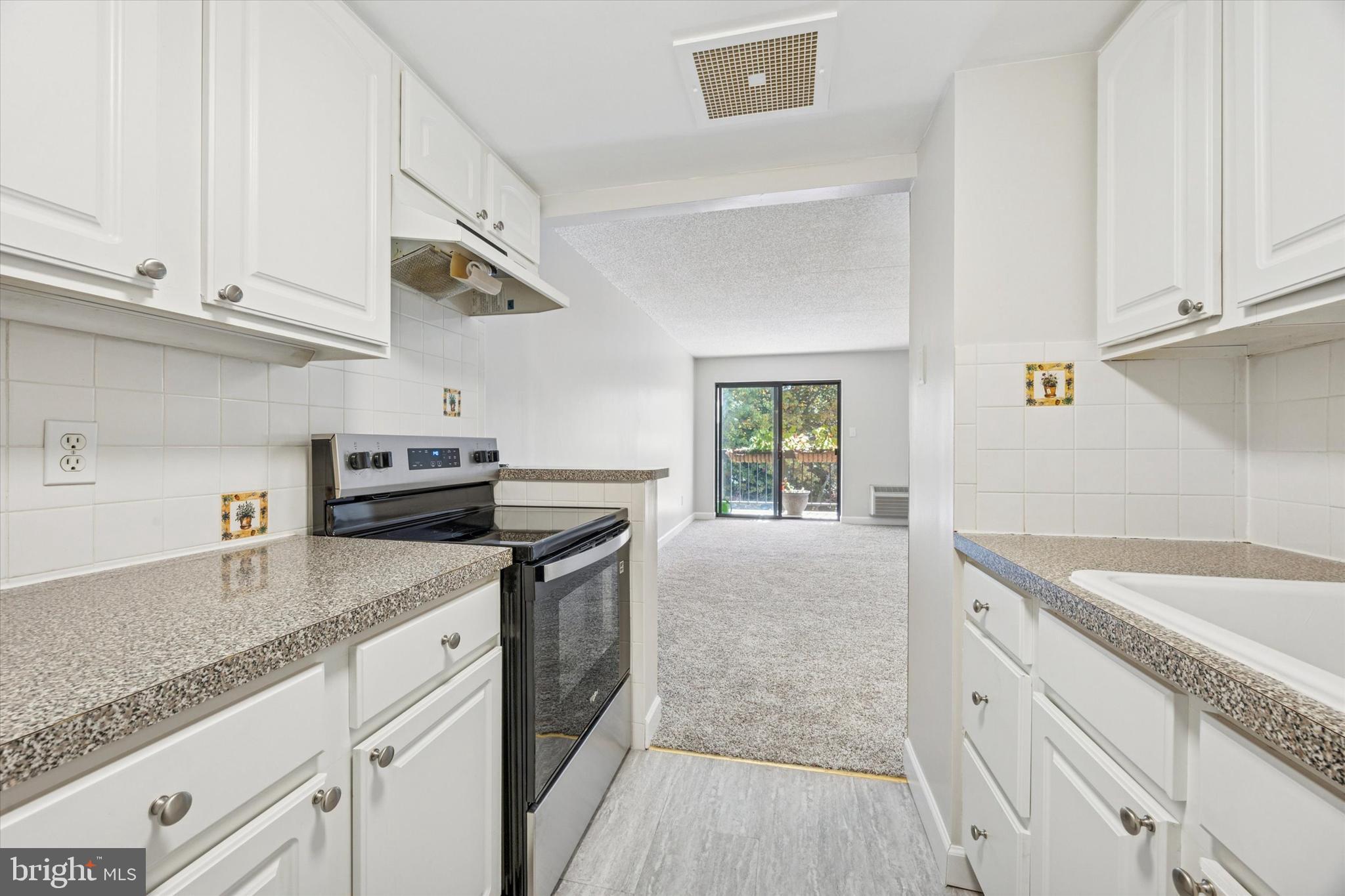800 Avondale Road, Unit 7B Wallingford, PA 19086 - Photo 8 of 24 a kitchen with stainless steel appliances granite countertop a sink and a stove