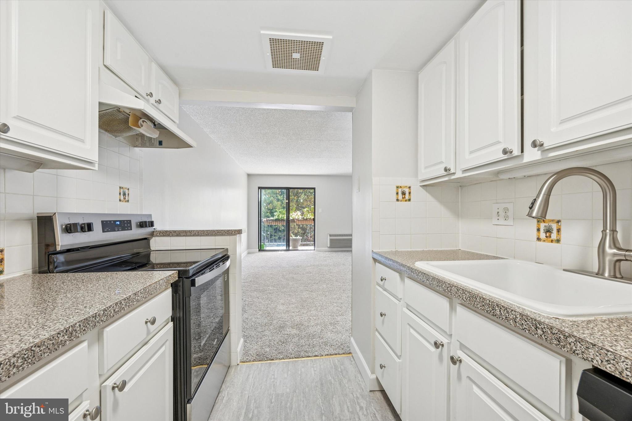 800 Avondale Road, Unit 7B Wallingford, PA 19086 - Photo 9 of 24 a kitchen with granite countertop a sink stainless steel appliances and cabinets