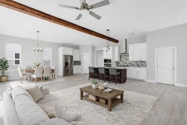 a living room with furniture and kitchen view