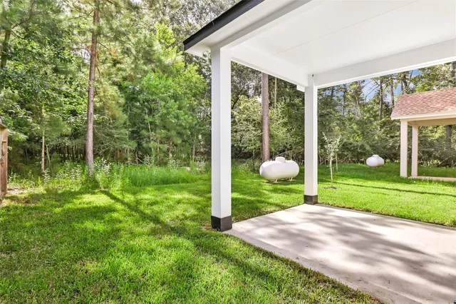 a backyard of a house with garden and plants
