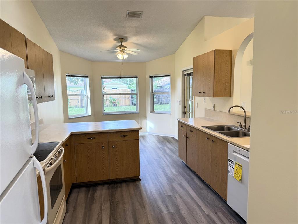 54 Westmount Lane Palm Coast, FL 32164 - Photo 15 of 32 a large kitchen with a wooden floor and cabinets