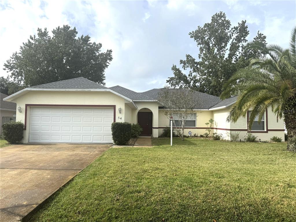 54 Westmount Lane Palm Coast, FL 32164 - Photo 2 of 32 a view of a house with a yard and large tree