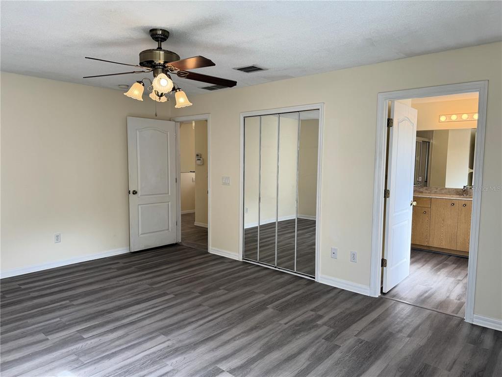 54 Westmount Lane Palm Coast, FL 32164 - Photo 23 of 32 wooden floor in an empty room with a window