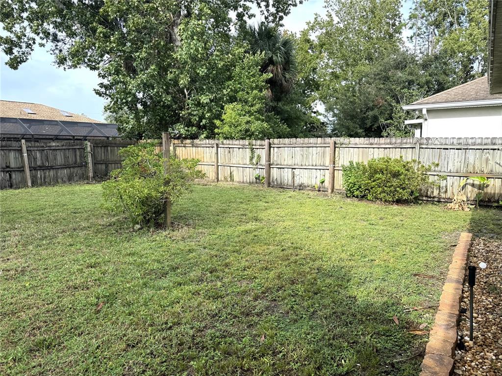 54 Westmount Lane Palm Coast, FL 32164 - Photo 28 of 32 a view of backyard with garden and trees