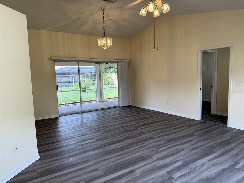 54 Westmount Lane Palm Coast, FL 32164 - Photo 5 of 32 an empty room with wooden floor and windows