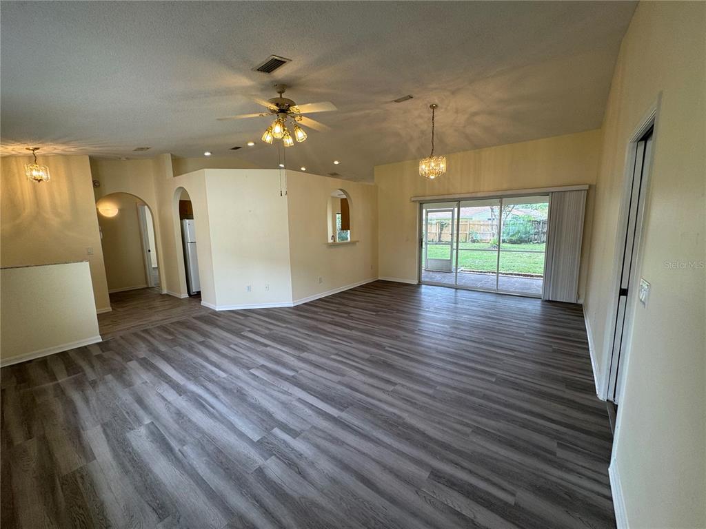 54 Westmount Lane Palm Coast, FL 32164 - Photo 6 of 32 wooden floor in an empty room with a window