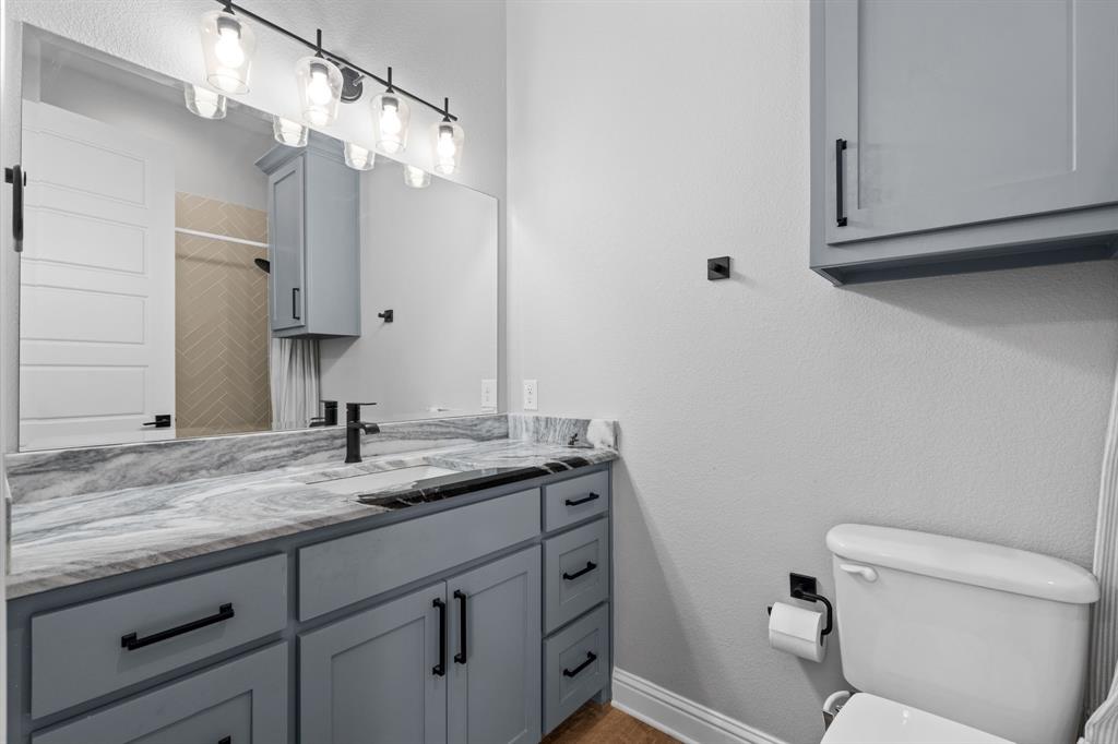 Tbd Tbd Anchor Point Quinlan, TX 75474 - Photo 27 of 40 a bathroom with a granite countertop sink a toilet and mirror