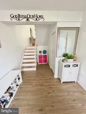 a view of a bedroom with wooden floor and entryway