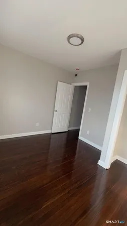 a view of a room with wooden floor