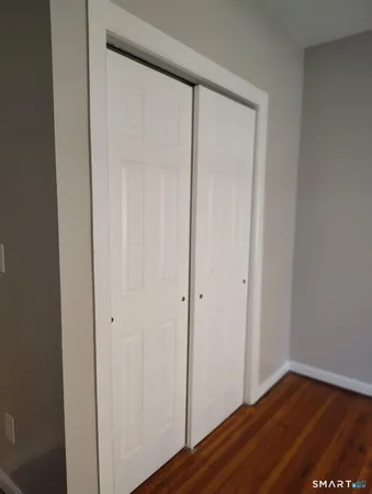 a view of front door with wooden floor