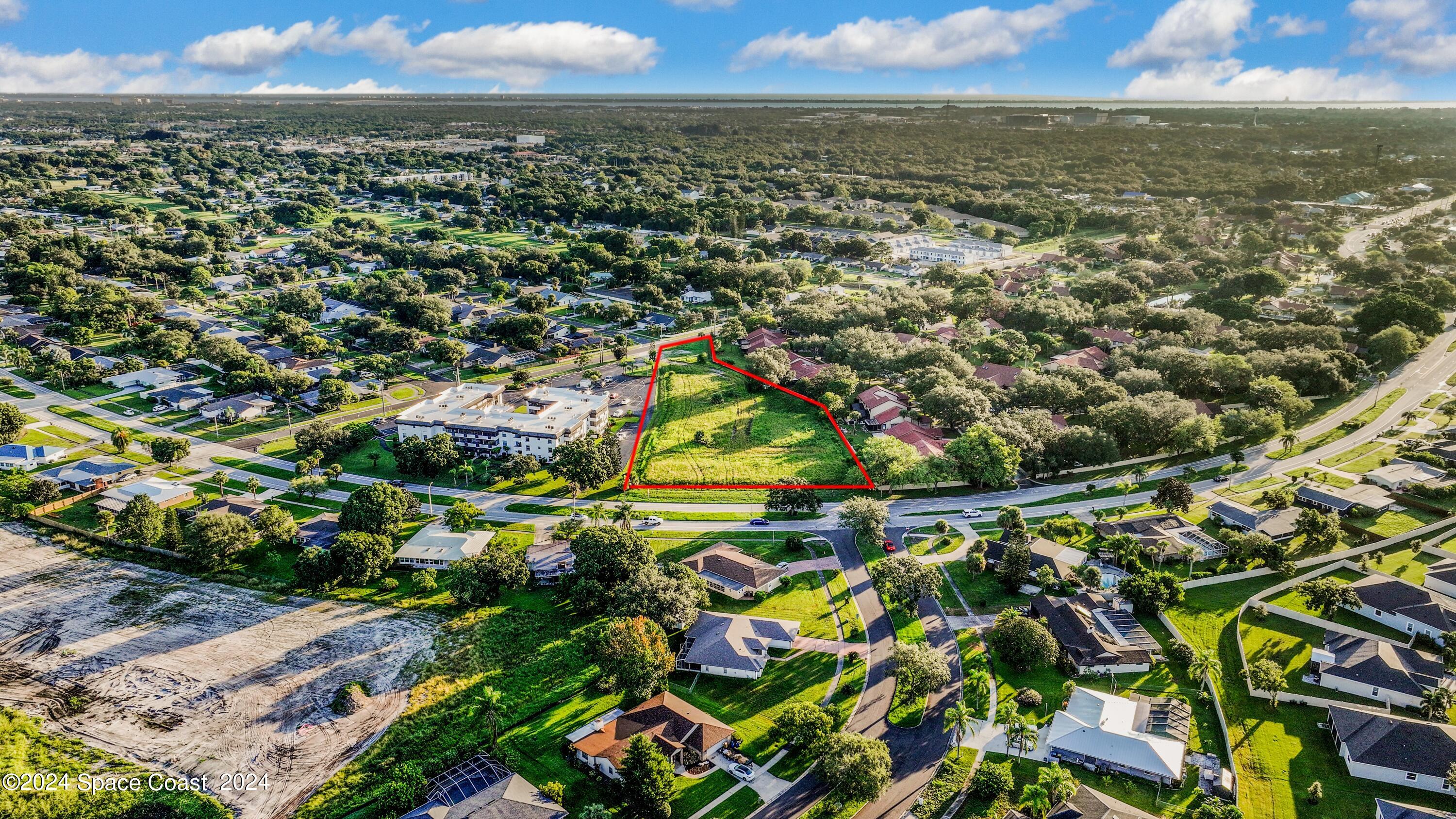 1460 Par Street Northeast Palm Bay, FL 32905 - Photo 11 of 16 an aerial view of residential houses with outdoor space and trees