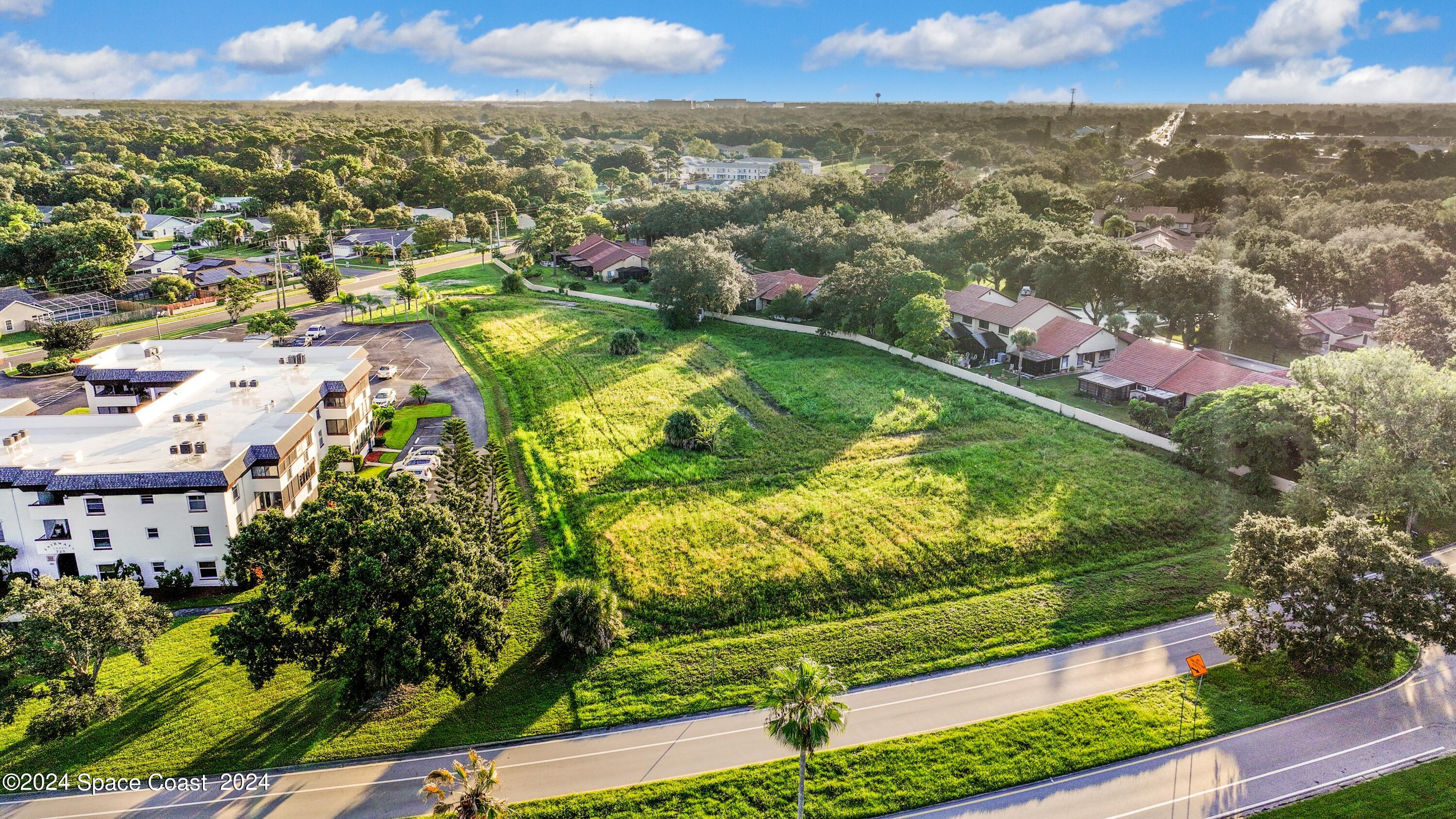 1460 Par Street Northeast Palm Bay, FL 32905 - Photo 2 of 16 an aerial view of residential houses with outdoor space and trees