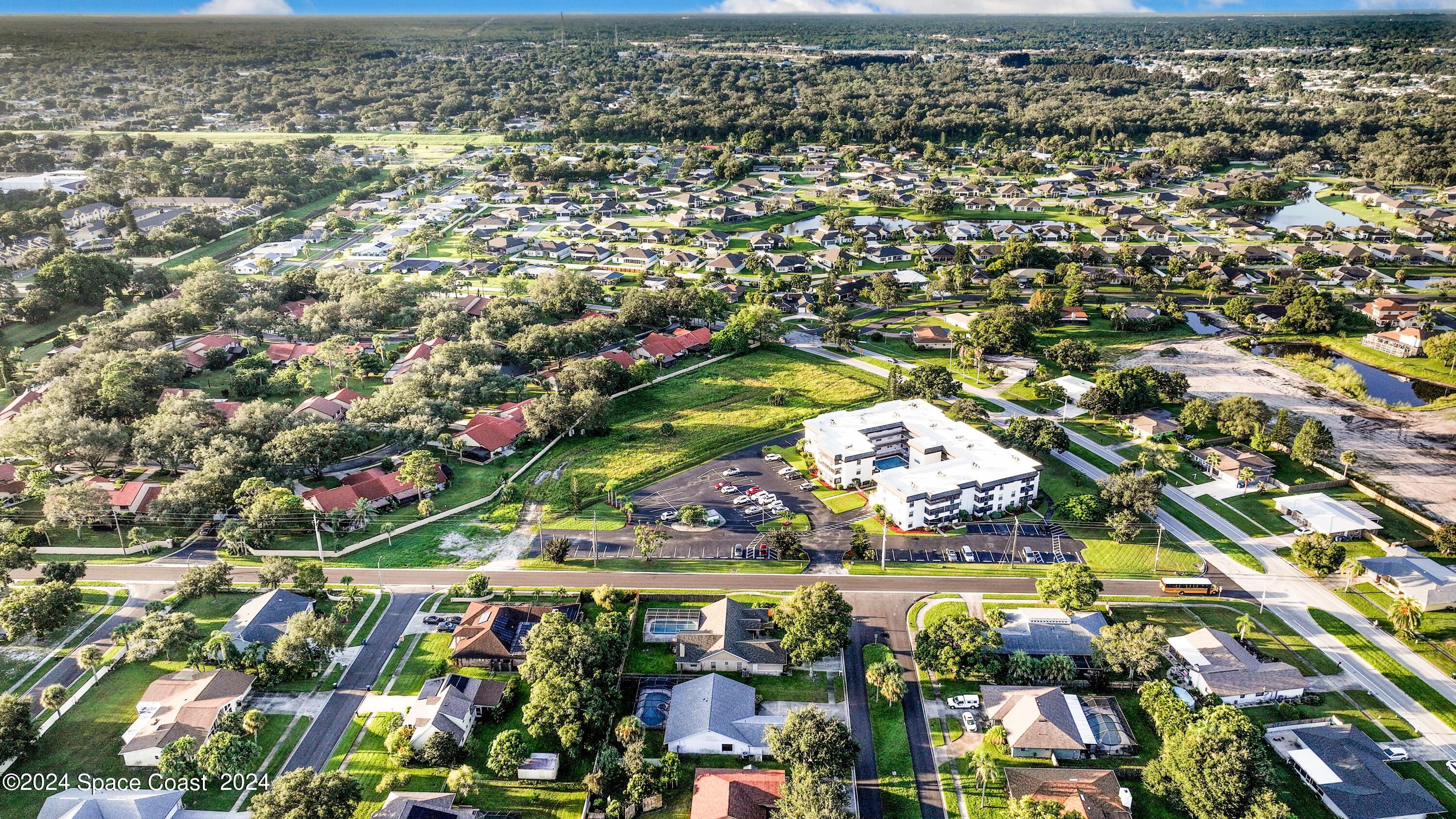 1460 Par Street Northeast Palm Bay, FL 32905 - Photo 4 of 16 an aerial view of residential houses with outdoor space and swimming pool