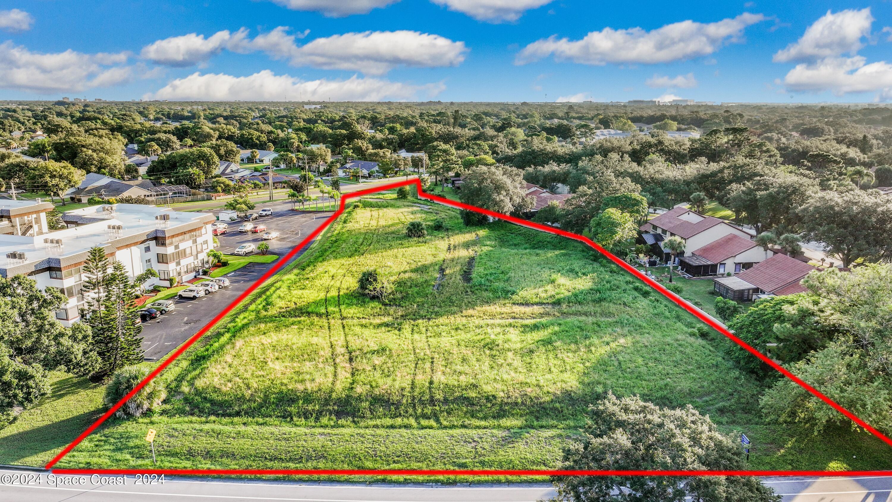 1460 Par Street Northeast Palm Bay, FL 32905 - Photo 9 of 16 a view of a yard with an umbrella and wooden floor