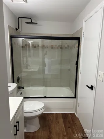 a bathroom with a shower a toilet and sink