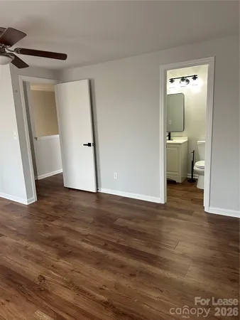 a view of a room with wooden floor and bathroom