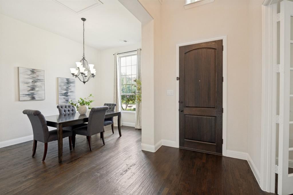 14215 Raspberry Lane Frisco, TX 75035 - Photo 2 of 30 Dark wood-finish flooring extending from the entryway into the dining space