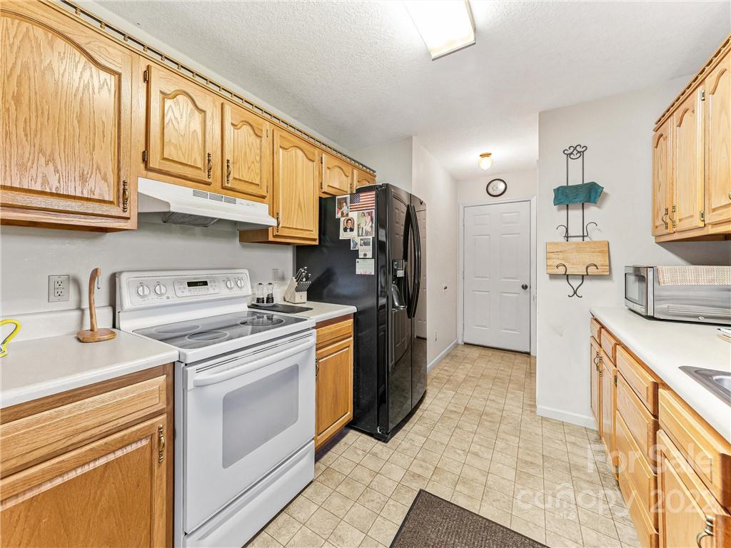 4411 Eller Ford Road Weaverville, NC 28787 - Photo 11 of 20 a kitchen with a sink stove and refrigerator