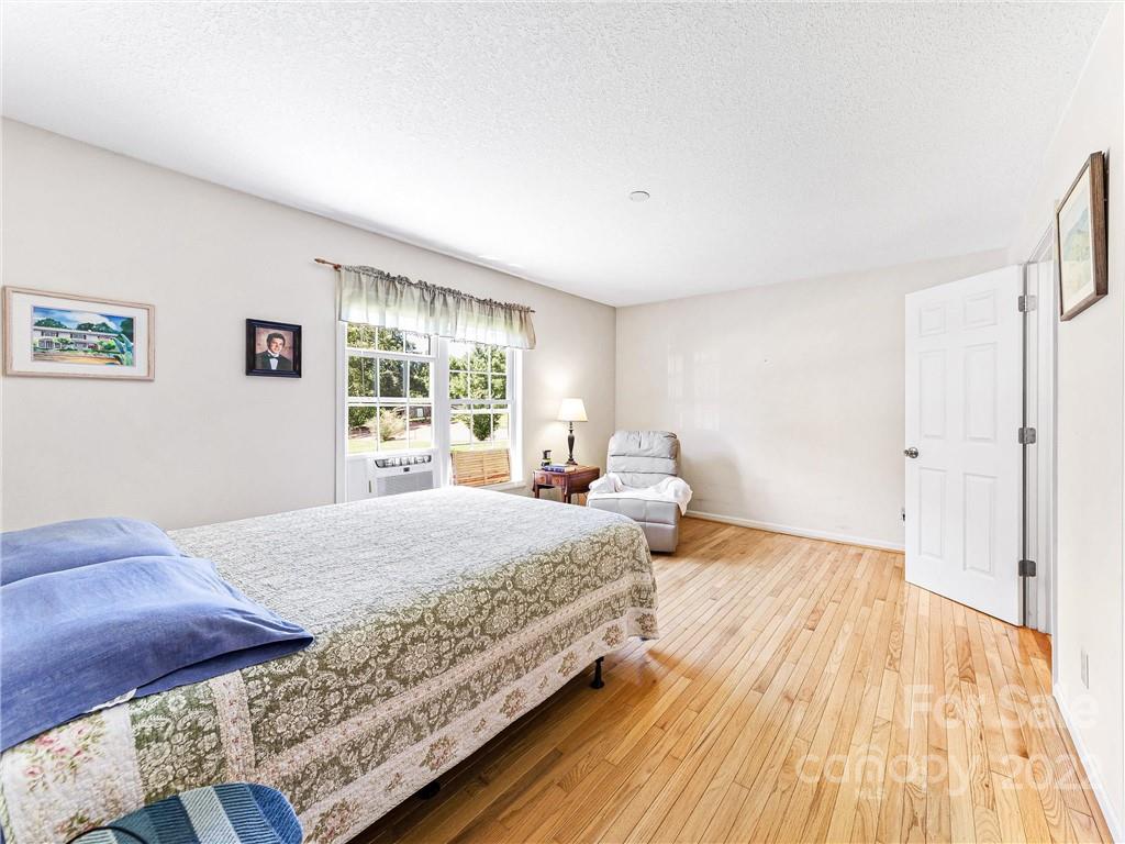 4411 Eller Ford Road Weaverville, NC 28787 - Photo 12 of 20 a bedroom with a bed and wooden floor