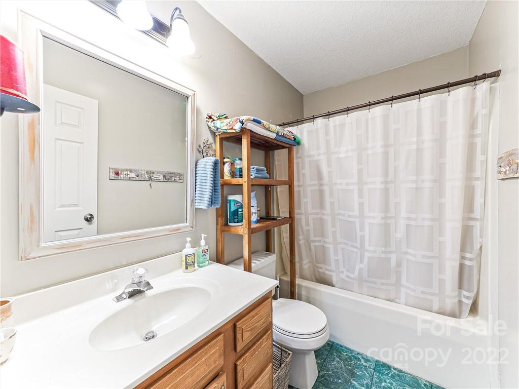 4411 Eller Ford Road Weaverville, NC 28787 - Photo 15 of 20 a bathroom with a sink toilet and shower